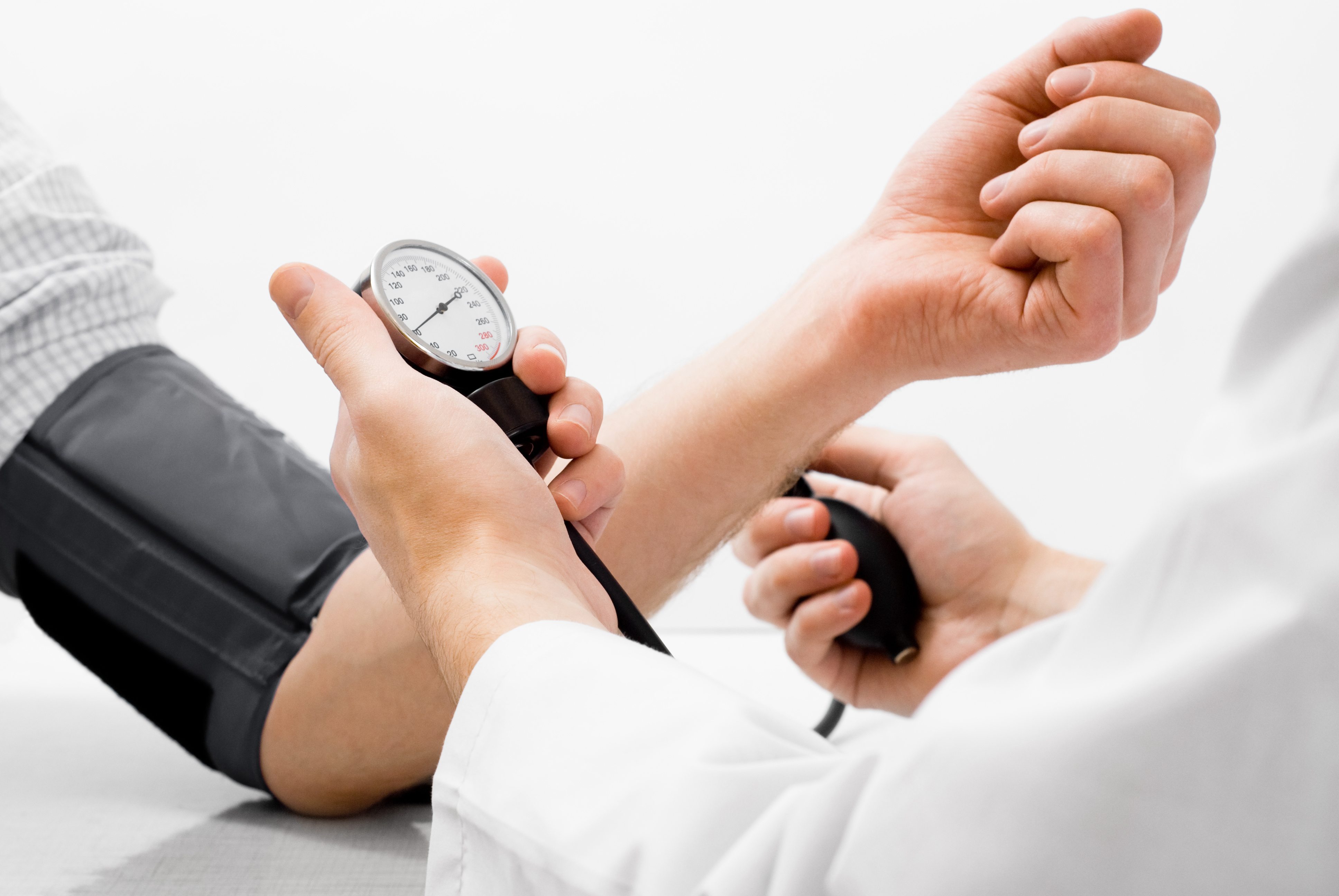 doctor taking blood pressure of insurance and medicaid patient